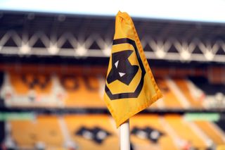 The Wolverhampton Wanderers badge on an orange corner flag at Molineux