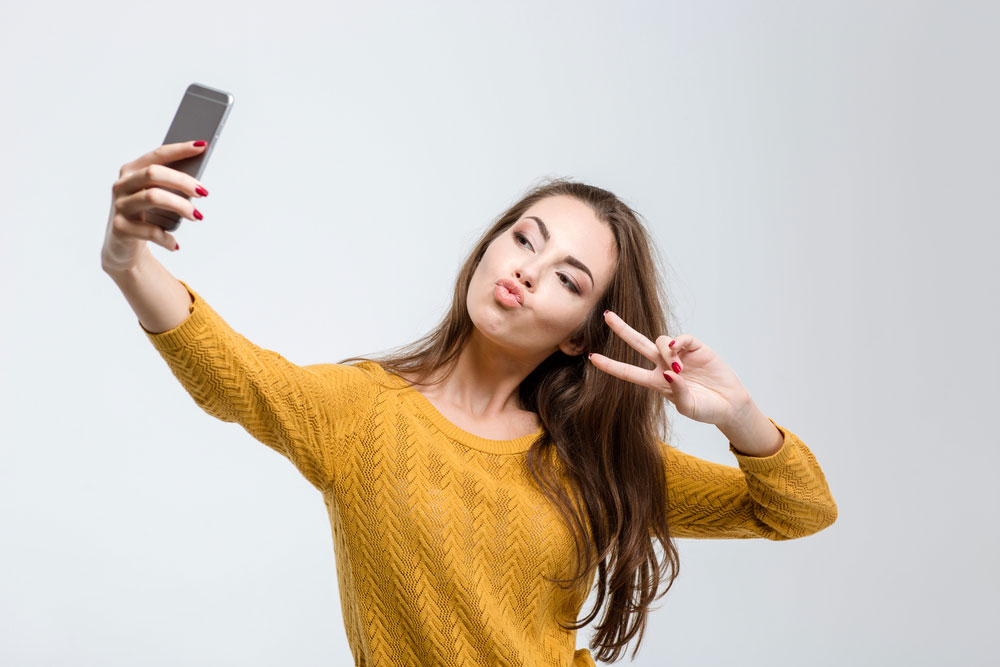 Young woman taking a selfie.