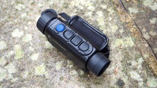 Pulsar Axion XQ30 PRO night vision monocular on a stone surface