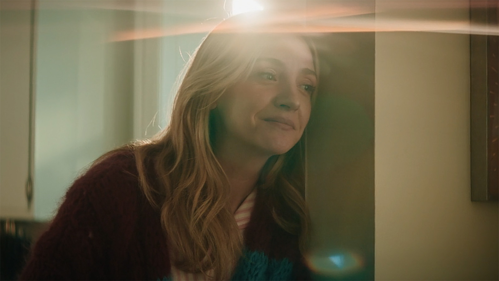 Natalie leaning against a wall and half-smiling in The Bear season 5