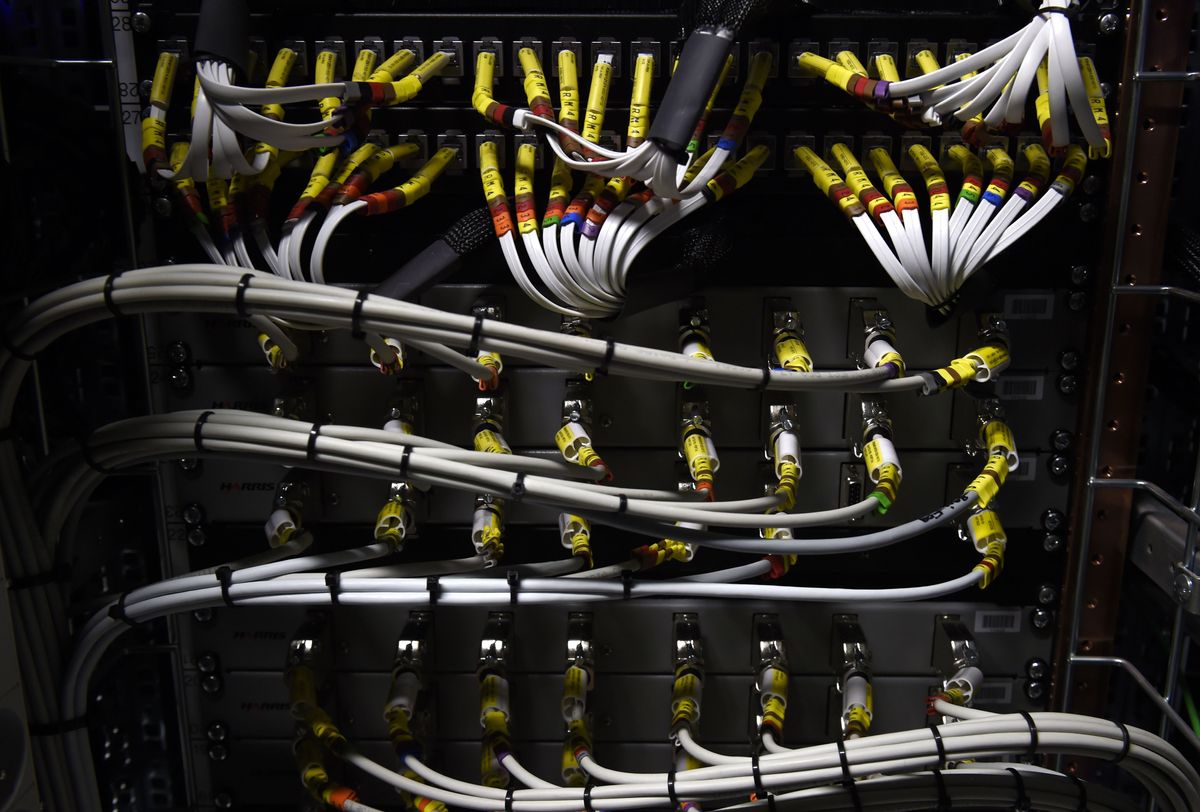 Picture of legacy IT infrastructure showing network cables plugged into a mainframe computing system