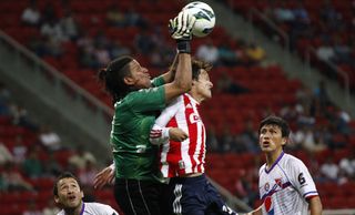 Fernando Patterson vies for the ball with Carlos Fierro in a CONCACAF Champions League match between Chivas and Xelaju MC in Guadalajara in 2012.