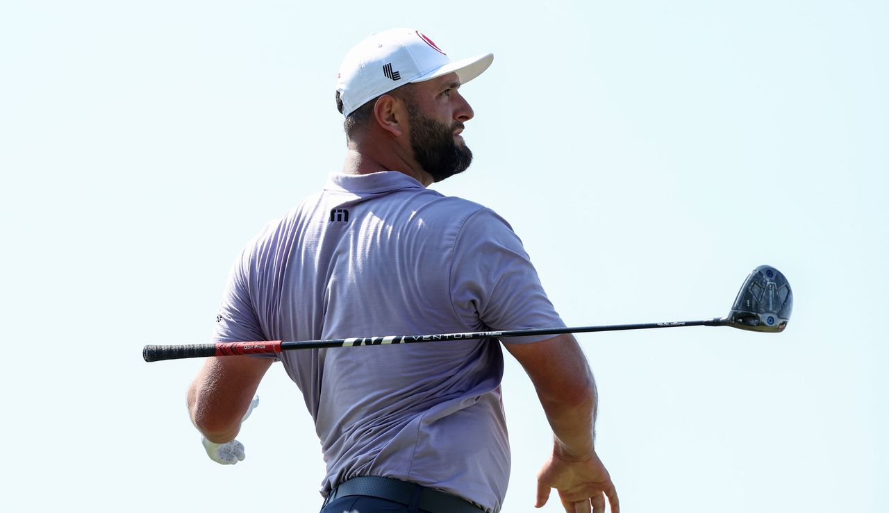 Jon Rahm drops his driver after a poor tee shot