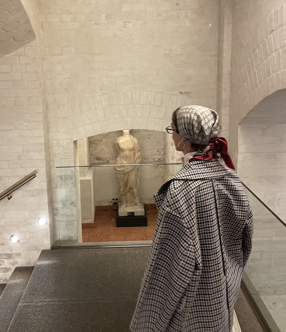 Larissa Mills wearing a gucci silk scarf around her head and a plaid jacket