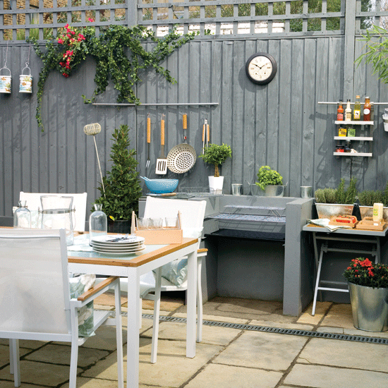 patio area with blue fence and dining table