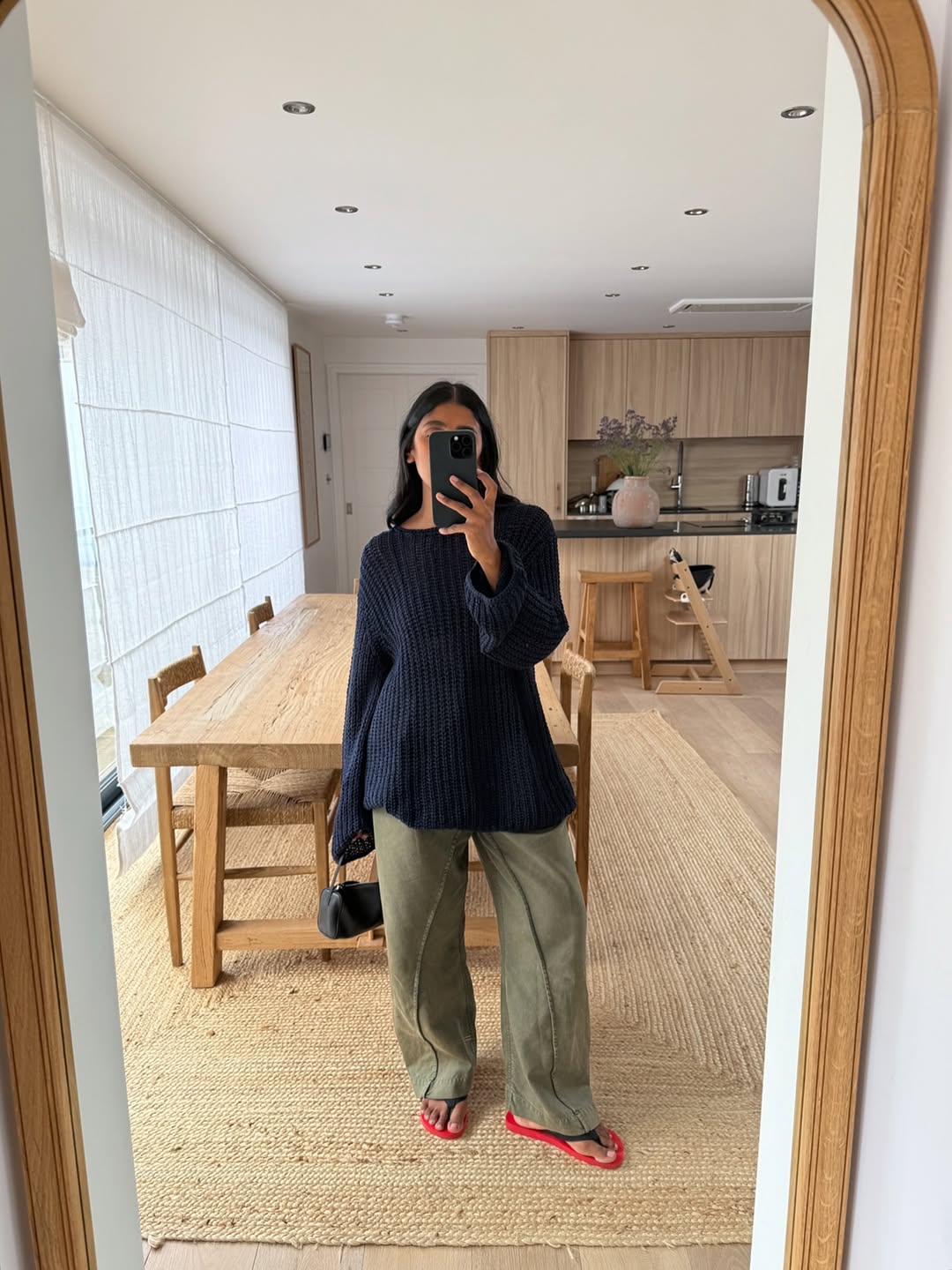 @monikh wears khaki jeans and navy jumper