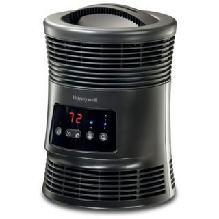 A black cylindrical Honeywell space heater