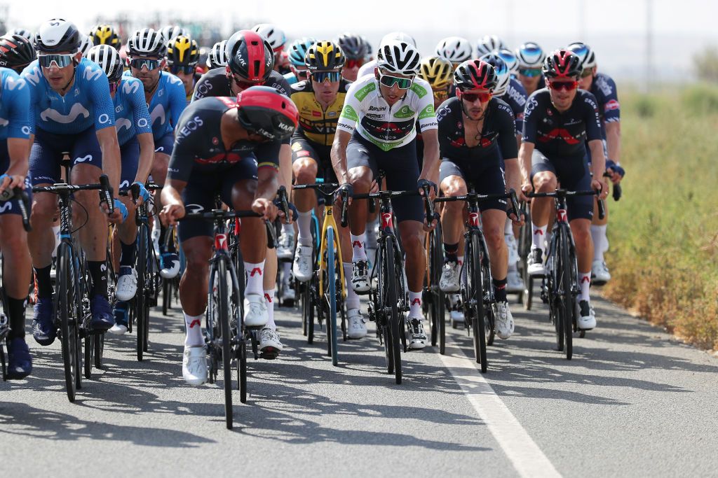 ALBACETE SPAIN AUGUST 18 LR Jhonnatan Narvaez Prado of Ecuador helps his teammate Egan Arley Bernal Gomez of Colombia and Team INEOS Grenadiers White Best Young Rider Jersey in final kilometres during the 76th Tour of Spain 2021 Stage 5 a 1844km stage from Tarancn to Albacete lavuelta LaVuelta21 on August 18 2021 in Albacete Spain Photo by Gonzalo Arroyo MorenoGetty Images