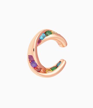Woman's earring for unpierced ears by Tada & Toy. A pink hoop with different colour gem stones embedded into it.