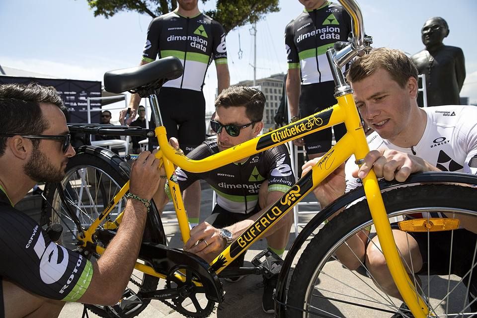 Dimension Data riders sign the Qhubeka Buffalo Bike for the raffle