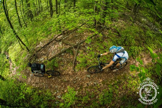 Mike Hebe follows close behind a rider descending a trail in Stage 3