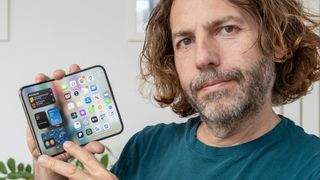 Adam Juniper holding iPhone Duo