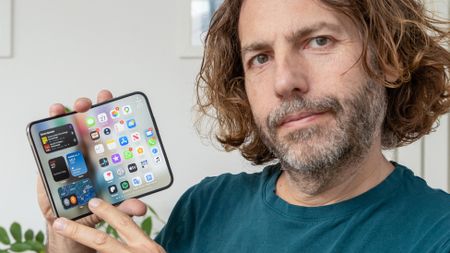 Adam Juniper holding iPhone Duo