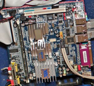 A closer look at the motherboard. Notice the hacked-together power regulator in the bottom left corner.