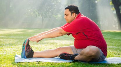 Overweight man over 35 exercising