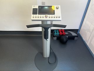Image of the EMS training machine with weights next to it