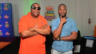 Kenan Thompson in Orange and Kel Mitchell in a blue shirt at the 2024 Nickelodeon Kid's Choice Awards backstage.