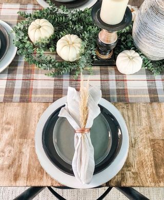 Plaid table runner with pampas and dried grasses wrapped on plate setting
