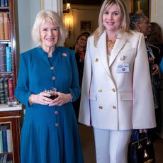 Britain's Camilla, Duchess of Cornwall and President of Women of the World Festival (L), meets actor Emerald Fennell, who portrayed the Duchess in the television series 'The Crown', during a reception to mark International Women's Day at Clarence House, in London, on March 8, 2022