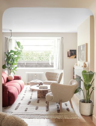 white living room with red sofa