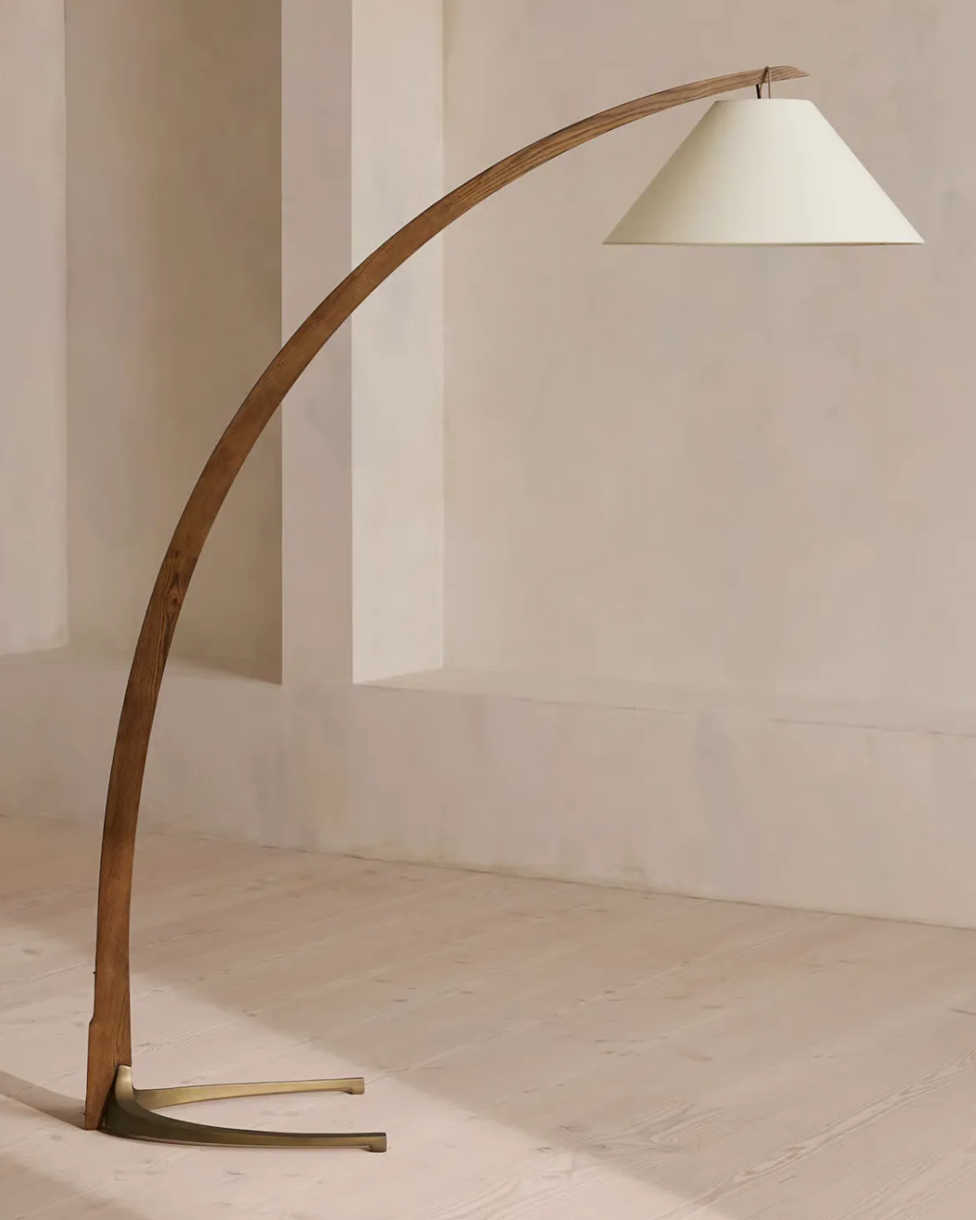 Spencer Arc Floor Lamp against beige background.