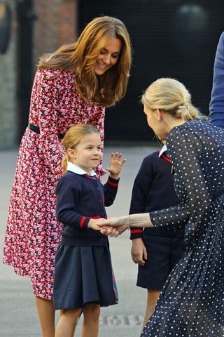 Helen Haslem, head of the lower school greets Princess Charlotte with the Duchess of Cambridge as she arrives for her first day of school at Thomas's Battersea in London on September 5, 2019 in London, England