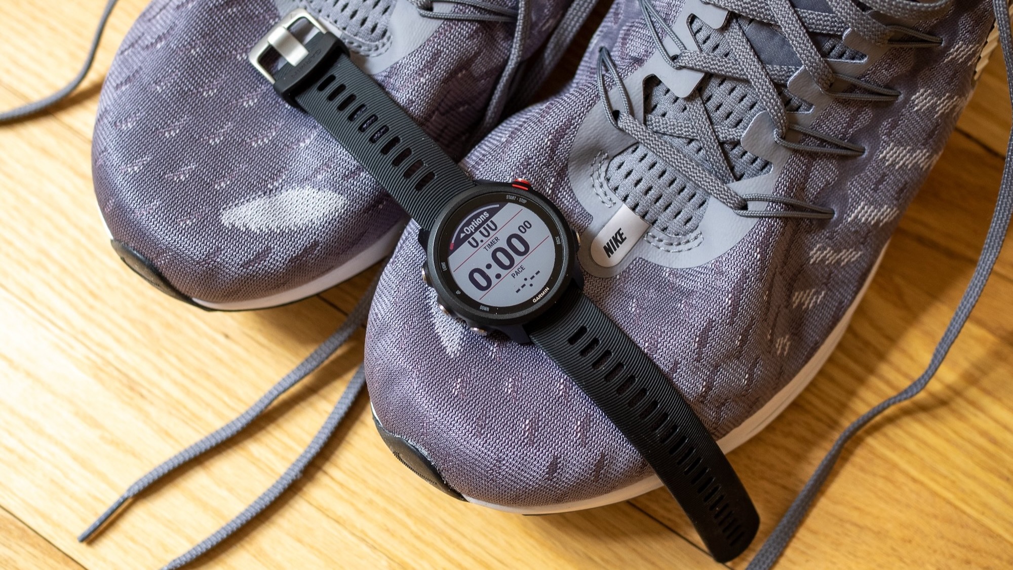 Garmin Forerunner 245 sitting on top of shoes