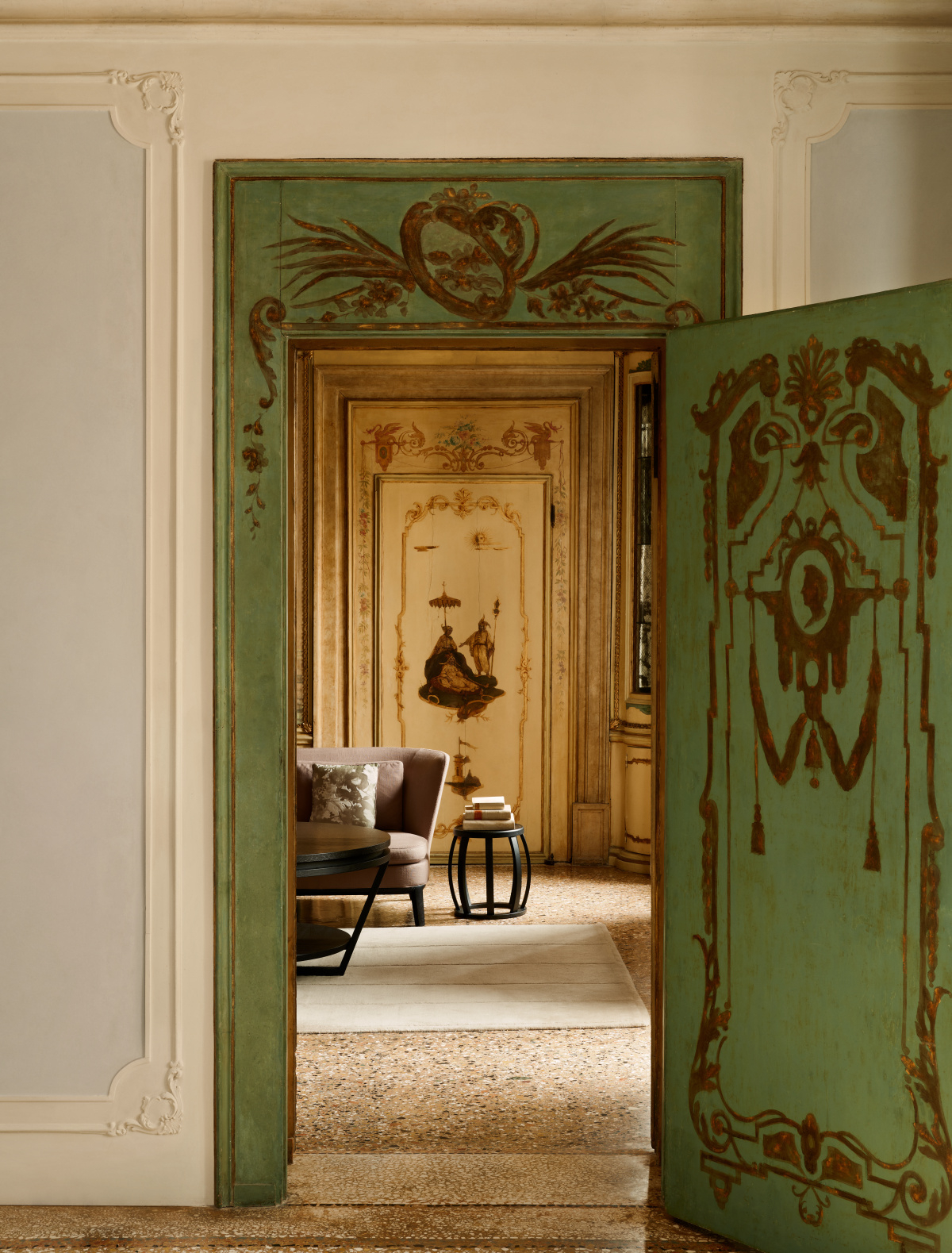 An ancient palazzo with distressed, painted doors and stuccoed walls is brought back to life through lavish contemporary furniture.