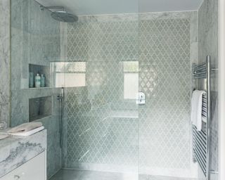 Pale blue wet room ideas with silver waterfall shower head.