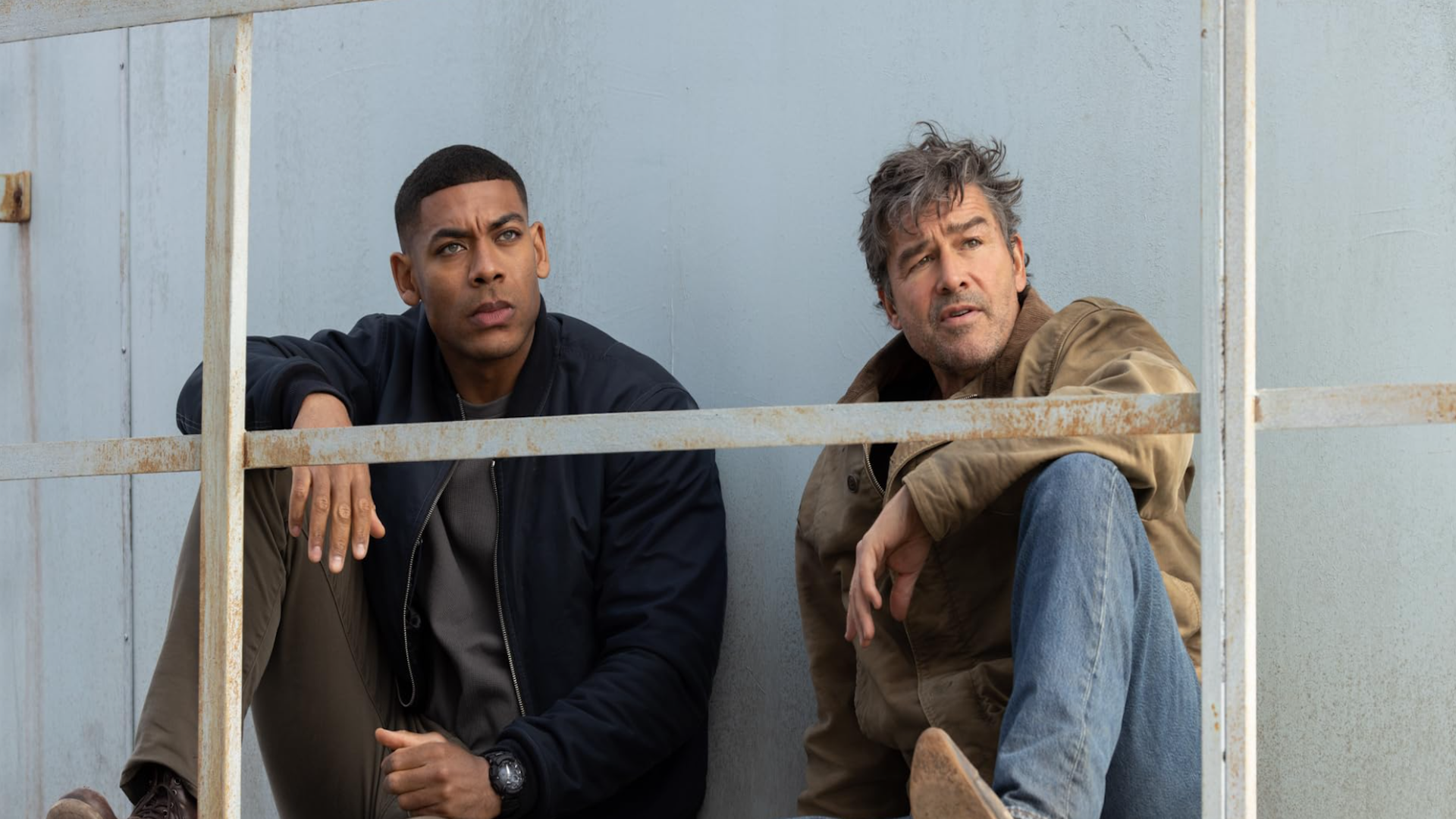 Two men in western wear sitting together