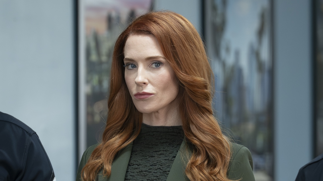 Monica being escorted by police through station in The Rookie Season 8