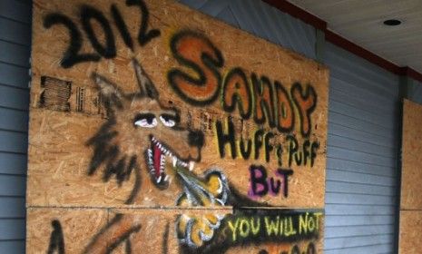 A New Jersey hair salon is protected by plywood taunting Hurricane Sandy on Oct. 28. So... who named Sandy, anyway?