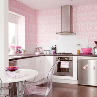 kitchen with pink wallpaper table and chair