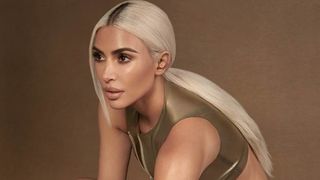 Kim Kardashian wearing a pair of Beats Fit Pro that match her skin tone