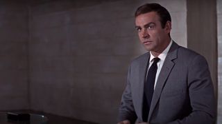 Sean Connery stands in an office with a questioning look in You Only LIve Twice.
