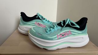 Hoka Bondi 9 running shoe product view on wooden platform