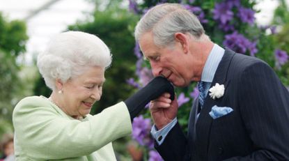 Queen Elizabeth II presents Prince Charles, Prince of Wales with the Royal Horticultural Society&#039;s Victoria Medal of Honour during a visit to the Chelsea Flower Show on May 18, 2009 in London. 