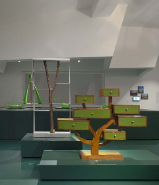 Wooden tree sculpture with green drawers