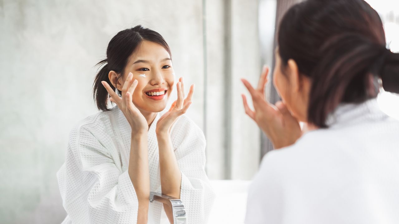 woman putting skincare make up on