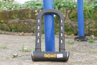 our best overall angle grinder resistant lock the onguard rocksoild resting against a bike rack