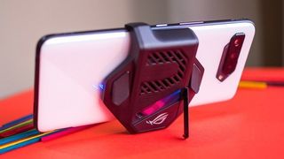 ASUS ROG Phone 5 with fan on and a stand