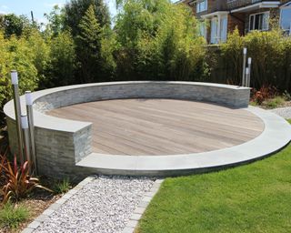 circular decked patio surrounded by a low wall