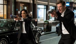 Tessa Thompson and Chris Hemsworth point space guns in Men In Black International