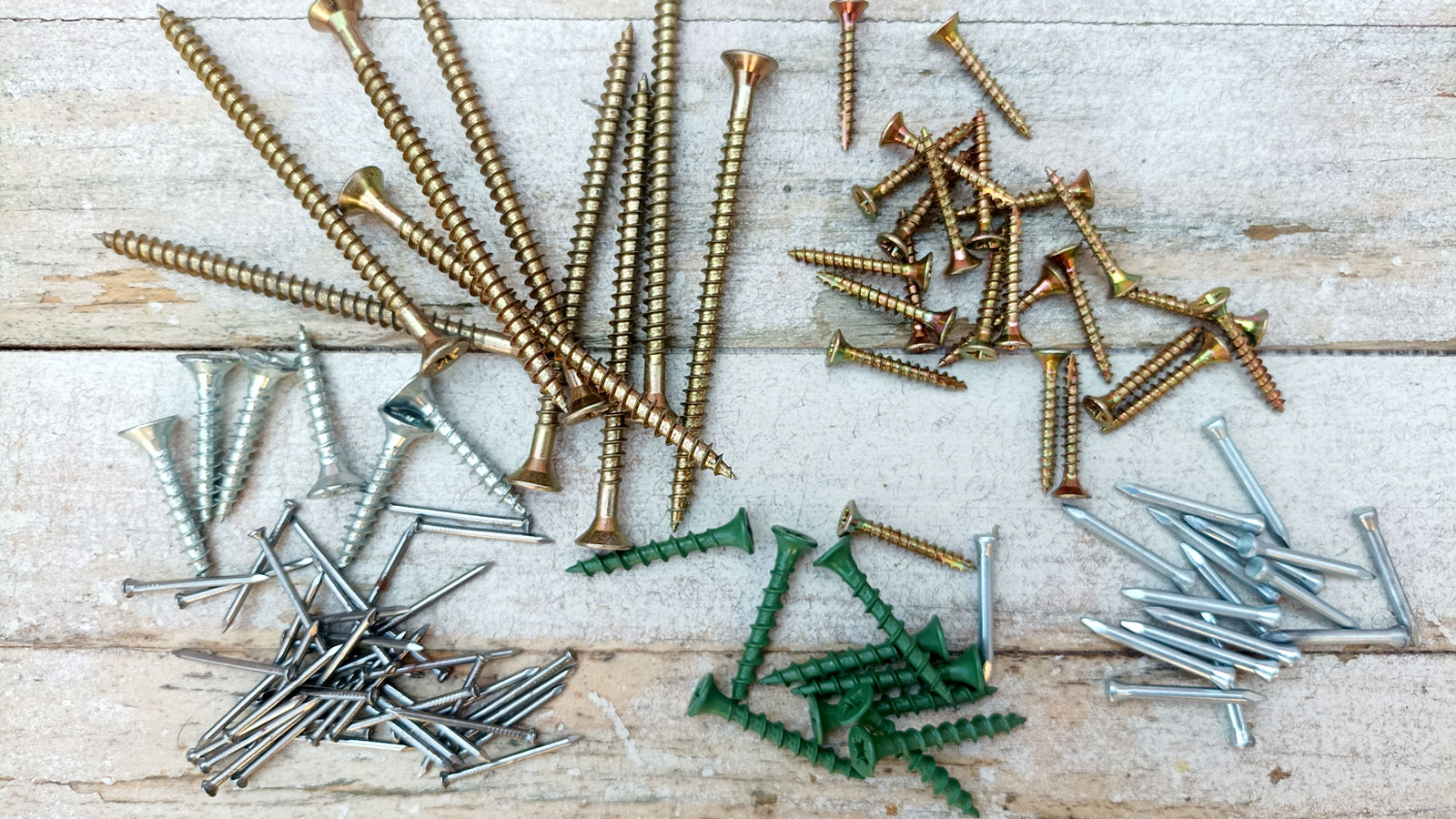Selection of nails and screws on whitewashed wood