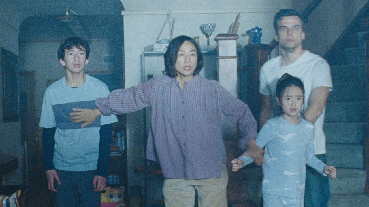 Ann, Jason and their sons standing shocked in living room in The Last House