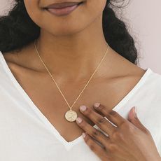 woman wearing zodiac necklace