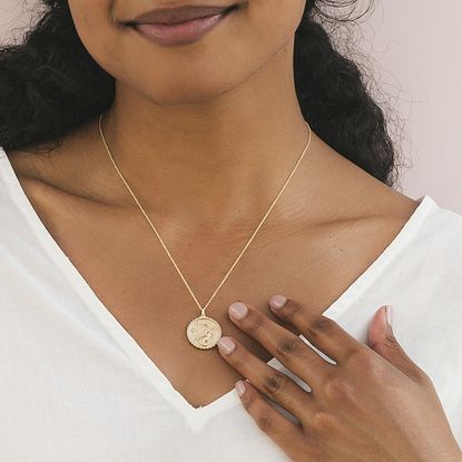 woman wearing zodiac necklace