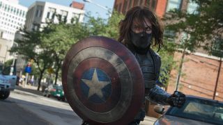 Masked Bucky Barnes as Winter Soldier holding Captain America's shield