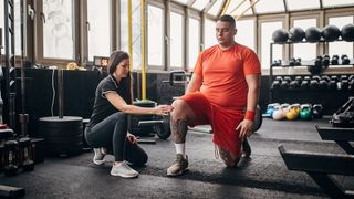 Personal trainer taking a man through his first workout