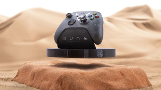 A floating Xbox controller on a Dune-themed stand.